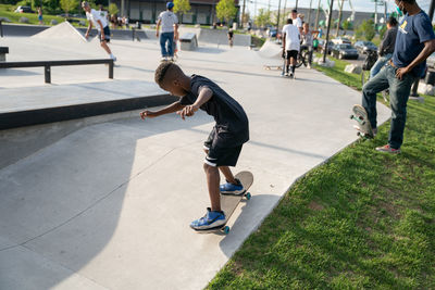 Rear view of boy skateboarding on skateboard