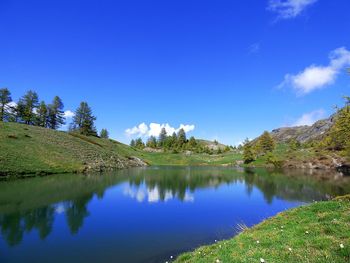 Scenic view of lake against blue sky