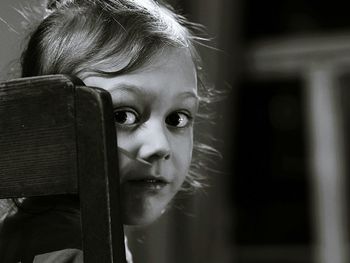 Close-up portrait of cute girl at home