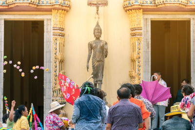 Rear view of people outside temple