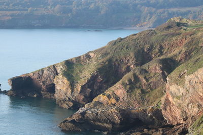 Scenic view of sea by mountains