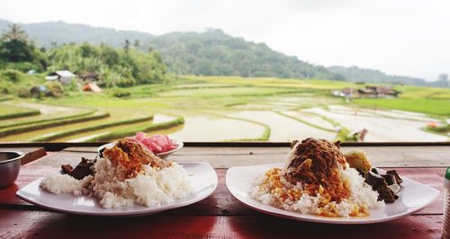 Close-up of food served on table by window