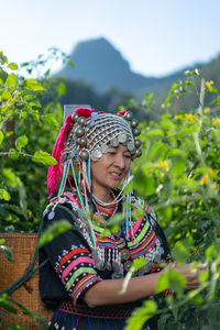 Woman in traditional clothing working at farm
