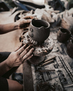 Cropped hand of woman holding coffee cup