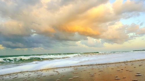 Scenic view of sea against cloudy sky