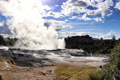 Scenic view of waterfall against sky