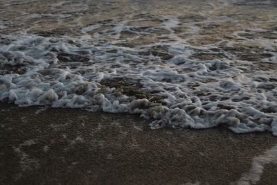 High angle view of surf on beach