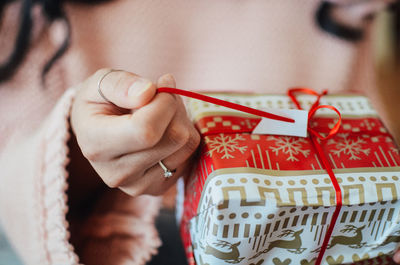 Close-up of woman hand holding red art