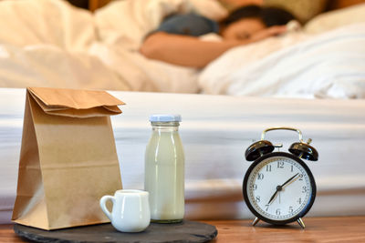 Close-up of clock on table at home