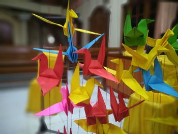 Close-up of multi colored umbrellas hanging on paper