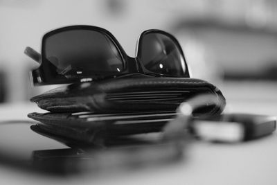 Close-up of sunglass and wallet on table