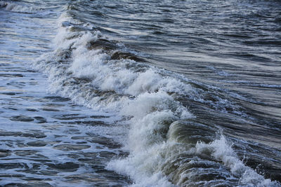 High angle view of waves rushing towards shore