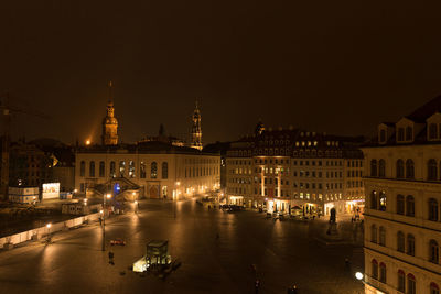 High angle view of buildings lit up at night