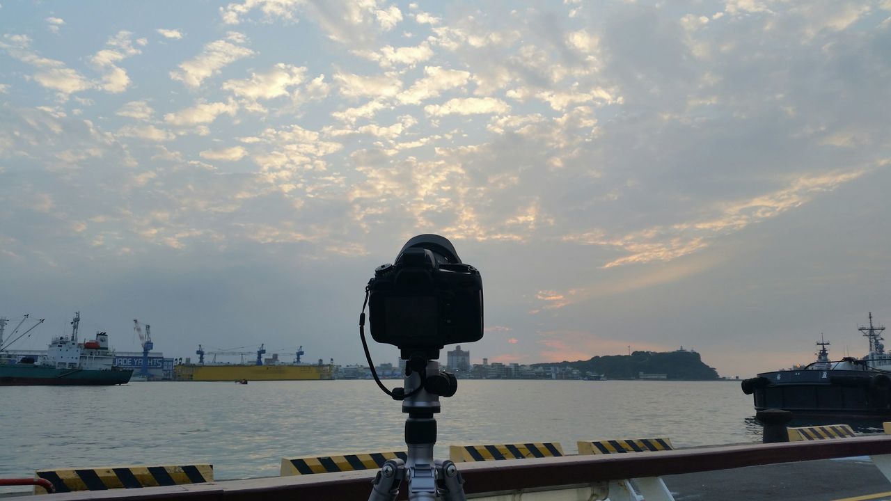 water, sky, cloud - sky, sea, nautical vessel, transportation, sunset, mode of transport, cloud, railing, cloudy, nature, built structure, one person, scenics, beauty in nature, tranquility, building exterior, river, outdoors