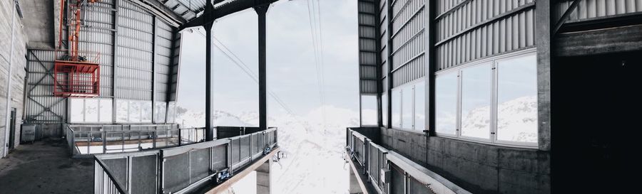 Bridge by buildings in city during winter