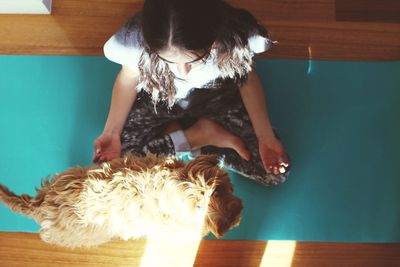 Full length of woman lying down on wooden floor