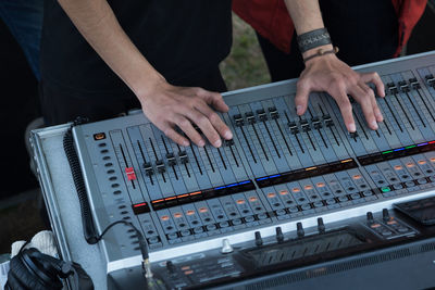 Midsection of man using sound mixer