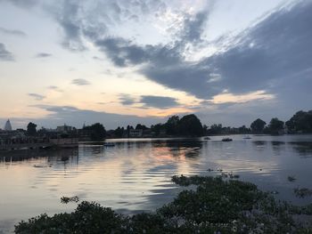 Scenic view of lake against sky at sunset