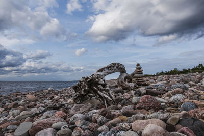 Rocks on beach against sky