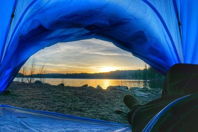 Close-up of beach against sky during sunset