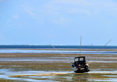 Man on boat in sea against sky