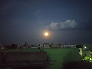 Scenic view of buildings against sky at night