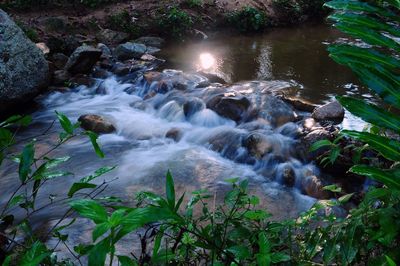 High angle view of waterfall on rocks by river