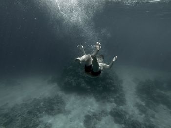 Close-up of man swimming underwater