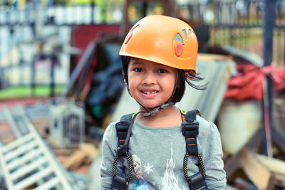 Portrait of little girl wearing helmet and harness