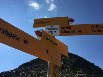 Low angle view of road sign against sky