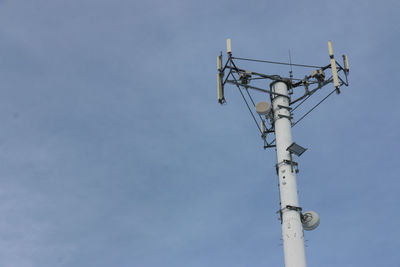 Low angle view of communications tower against sky