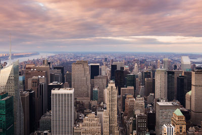 Aerial view of buildings in city against sky