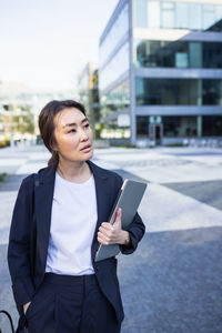 Portrait of young woman using mobile phone