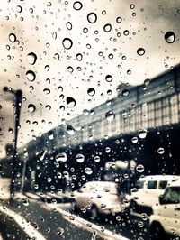 Road seen through wet car windshield