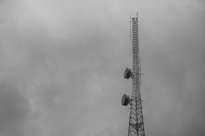 Low angle view of communications tower against sky