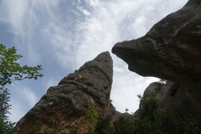 Low angle view of rock formation against sky