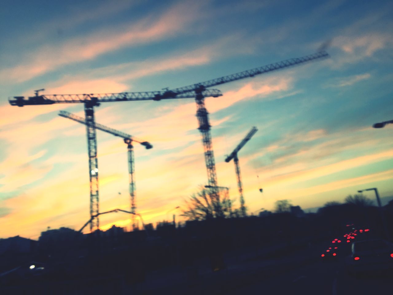 sunset, sky, cloud - sky, silhouette, orange color, no people, nature, technology, machinery, beauty in nature, outdoors, crane - construction machinery, focus on foreground, construction industry, electricity, communication, connection, electricity pylon, dramatic sky, industry, power supply