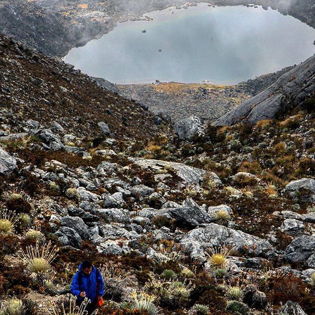 leisure activity, lifestyles, mountain, nature, men, tranquility, rock - object, beauty in nature, landscape, tranquil scene, sky, person, rear view, standing, scenics, high angle view, day