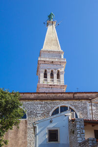 Low angle view of building against clear blue sky