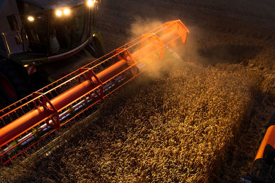 High angle view of machinery harvesting plants on field