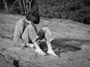 Full length of man sitting on field