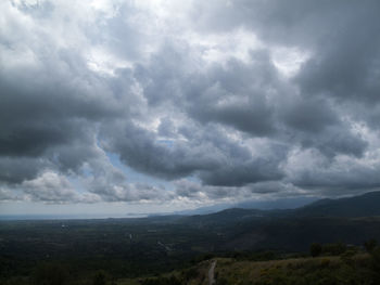 Scenic view of storm clouds over landscape