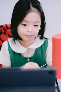 Girl looking away while sitting on mobile phone