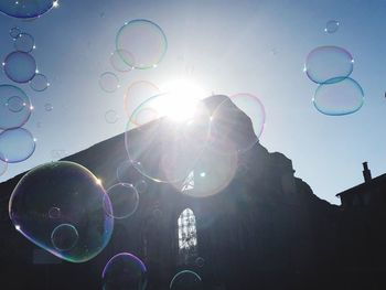 Low angle view of bubbles against sky