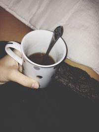 Cropped image of woman holding coffee cup