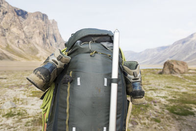 Rear view of backpack on hikers back in akshayuk pass. on the move