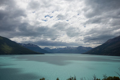 Scenic view of lake and mountains against sky