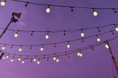 Low angle view of illuminated lights hanging from ceiling