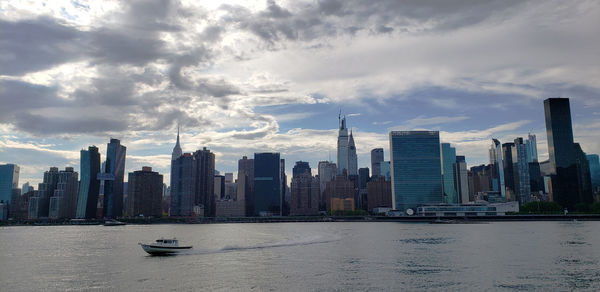 Panoramic view of modern buildings in city against sky