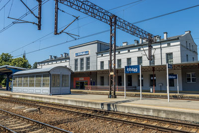 Railroad station platform against clear sky, train station in elblag, poland.